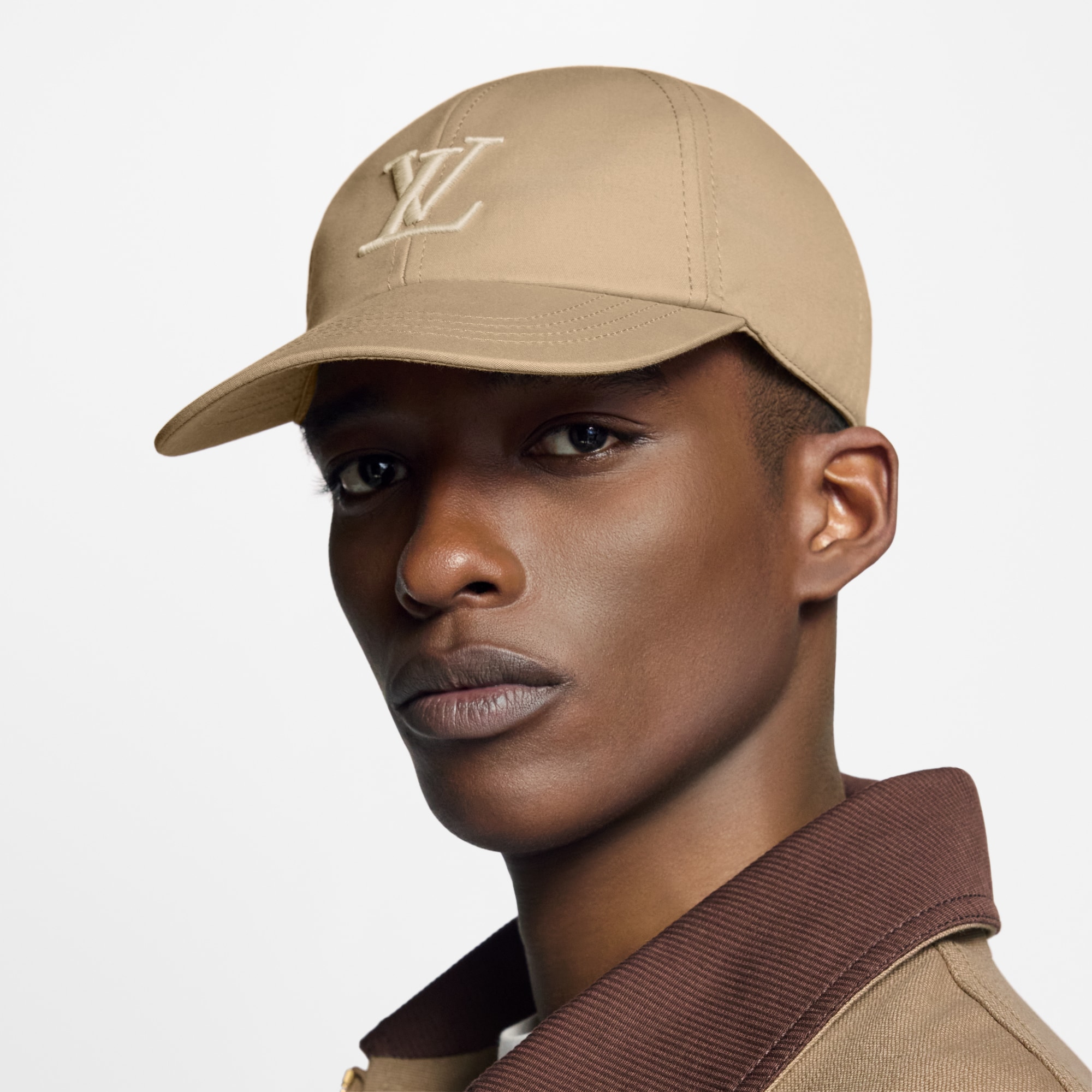 Model wearing a beige Louis Vuitton Only LV Cap with tonal embroidery.